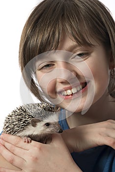 Happy litle girl with African pygmy hedgehog