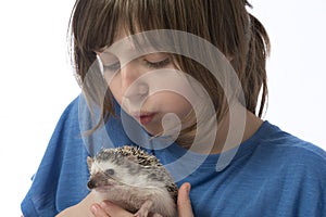 Happy litle girl with African pygmy hedgehog