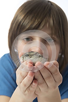 A happy litle girl with a cute hamster