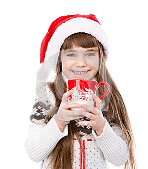 Happy litle girl enjoying big mug of hot drink. isolated on white