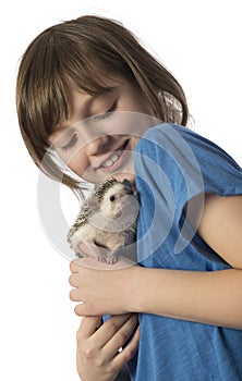Happy litle girl with her pet African pygmy hedgehog