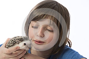 Happy litle girl with her pet African pygmy hedgehog