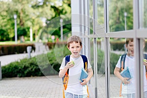 Happy little 7 years old boy at his first day at school