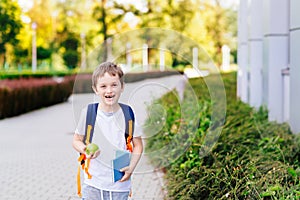 Happy little 7 years old boy at his first day at school