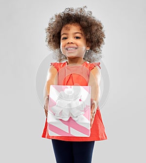 Happy little african american girl with gift box