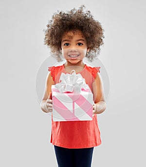 Happy little african american girl with gift box