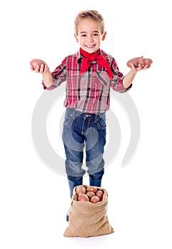 Happy little agriculturist showing potato harvest photo