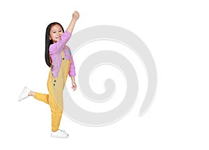 Happy little Asian child girl in pink-yellow dungarees freedom movement over white background with copy space. Kid activity