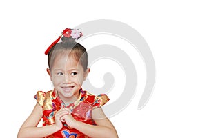 Happy little Asian child girl wearing red cheongsam with greeting gesture celebration for Chinese New Year isolated on white