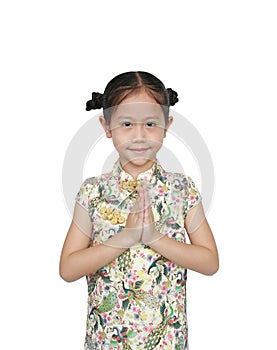 Happy little Asian kid girl wearing cheongsam with greeting gesture celebration for Chinese New Year