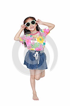 Happy little Asian kid girl wearing a flowers summer dress and sunglasses isolated on white background. Summer fashion kid concept