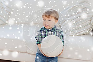 Happy little baby boy with ball at home