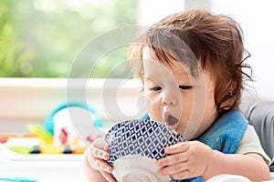 Happy little baby boy eating food