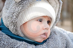 Happy little baby boy making outdoors in winter. Cute toddler in winter cloth. Child having fun on cold day. Winter walk