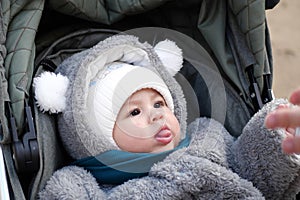 Happy little baby boy making outdoors in winter. Cute toddler in winter cloth. Child having fun on cold day. Winter walk