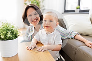 Happy little baby boy with mother at home