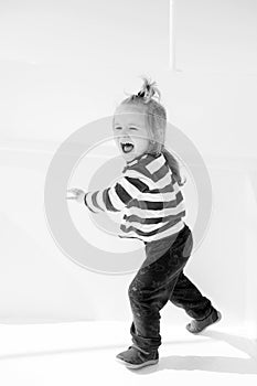 Happy little baby captain on boat, nautical kid fashion