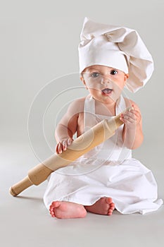 Happy little baby in a cook cap laughs