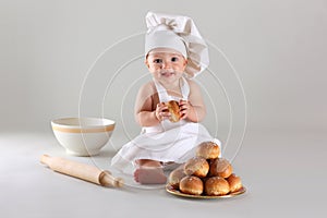 Happy little baby in a cook cap laughs