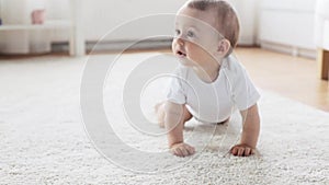 Happy little baby crawling in living room at home 8