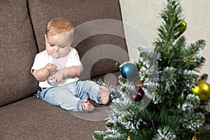 Happy little baby decorates christmas tree