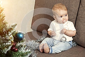 Happy little baby decorates christmas tree