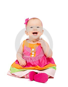 happy little baby girl in bright multicolored festive dress isolated