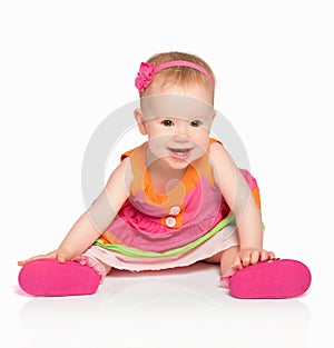 happy little baby girl in bright multicolored festive dress isolated