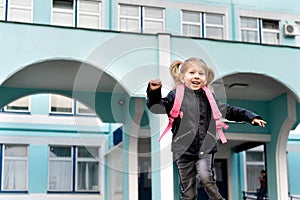 Happy little blonde girl flees school, concept of training preschoolers