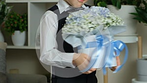 Happy little boy with big bouquet of flowers, hands close-up