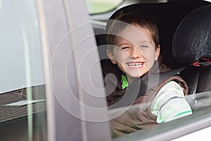 Happy little boy in car safety seat.