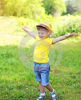 Happy little boy child having fun playing in summer