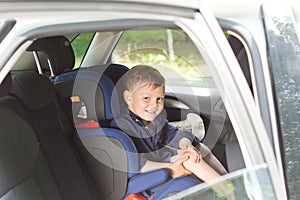 Happy little boy in a child seat