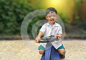 Happy little boy drive toy car.Playful kid at playground