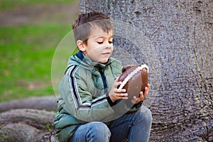 happy little boy with easter chocolate egg in the park