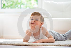 Happy little boy exercising at home