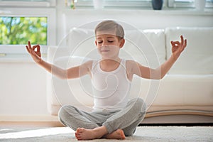 Happy little boy exercising at home