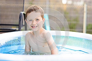 Happy little boy in garden pool