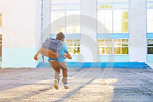 Happy little boy, high jumped with joy, the beginning of the school year.happy child goes to primary school. positive attitude to