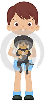 Happy little boy holding dachshund puppy