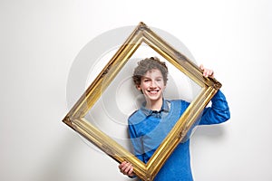 Happy little boy holding picture frame