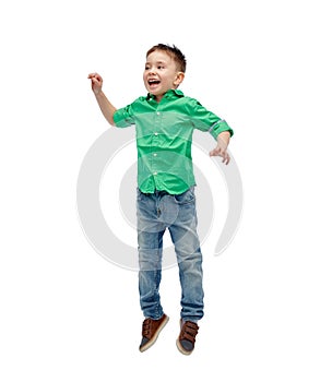 Happy little boy jumping in air