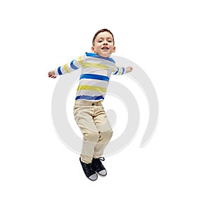 Happy little boy jumping in air