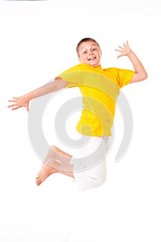 Happy little boy jumping isolated on white background.