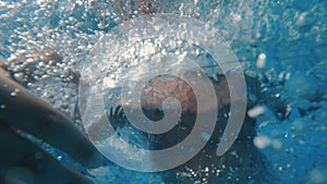 Happy little boy jumping pool blue clear water. Summer swim, underwater leisure