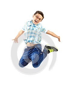 Happy little boy jumping on white