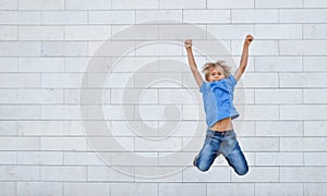 Happy little boy jumps on high. People, childhood, happiness, freedom, movement concept