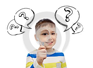 Happy little boy looking through magnifying glass