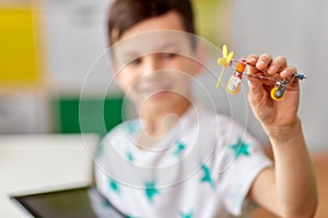 Happy little boy playing with airplane toy at home