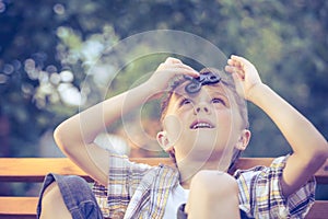 Happy little boy playing in the park at the day time.